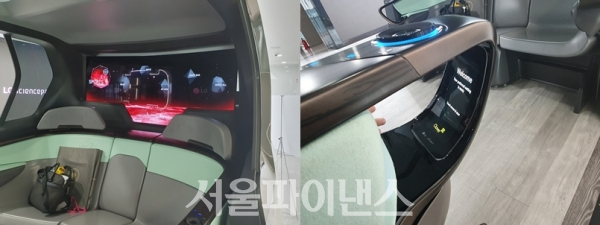 좌석 뒷편에는 대형 올레드 디스플레이가 있어서 동영상 콘텐츠, 음악, 실시간 도로 정보 등을 다양하게 즐길 수 있다. 또 내부 손잡이에는(사진 오른쪽) 소형 디스플레이가 있어 좌석 높이의 조정 냉난방 등의 조정이 가능하다. (사진=이호정 기자)