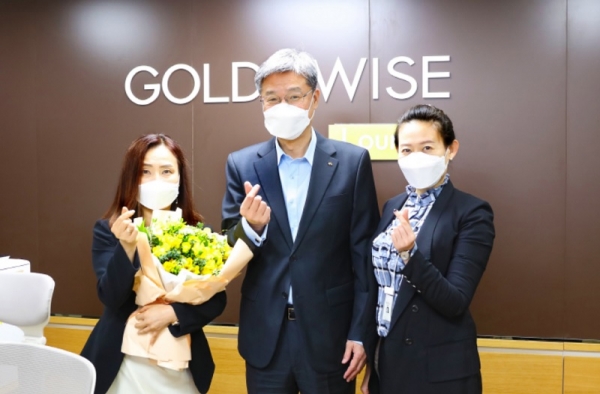 허인 KB국민은행장(가운데)이 지난 8일 여의도영업부를 방문해 직원들에게 프리지아 꽃을 전달하며 기념촬영을 하고 있다. (사진=KB국민은행)