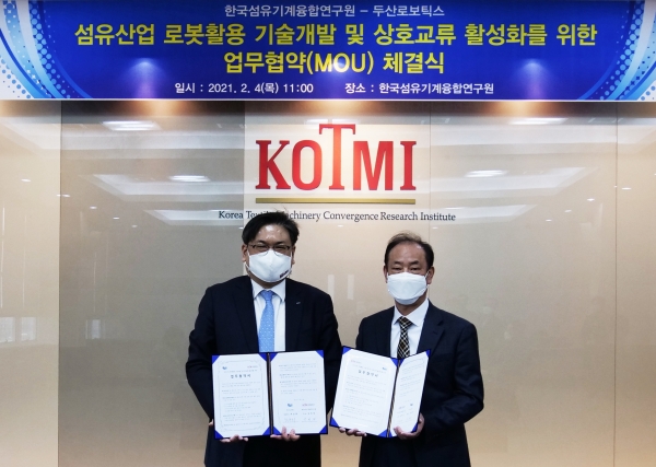 최동휘 두산로보틱스 대표(왼쪽)와 성하경 KOTMI 원장이 '섬유산업 제조현장 자동화 기술 개발' 업무협약식을 마치고 기념사진을 촬영하고 있다. (사진=두산로보틱스)