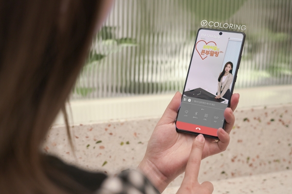 SK텔레콤 홍보 모델이 V 컬러링을 보고 있는 모습. (사진=SK텔레콤)