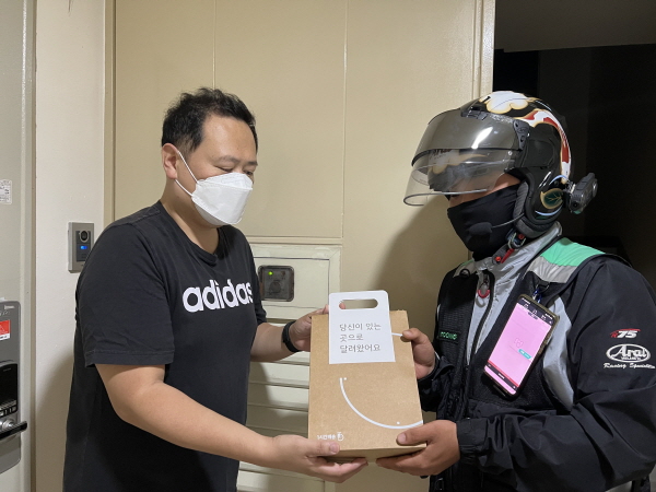 아이폰13 출시일인 8일 자정에 KT의 '미드나잇배송'으로 아이폰13을 직접 전달하고 있는 모습. (사진=KT)