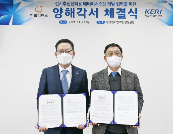 손재일 한화디펜스 대표(왼쪽)와 명성호 한국전기연구원장이 전기추진선박용 배터리시스템 개발 협력을 위한 양해각서를 체결한 뒤 기념촬영을 하고 있다. (사진=한화디펜스)