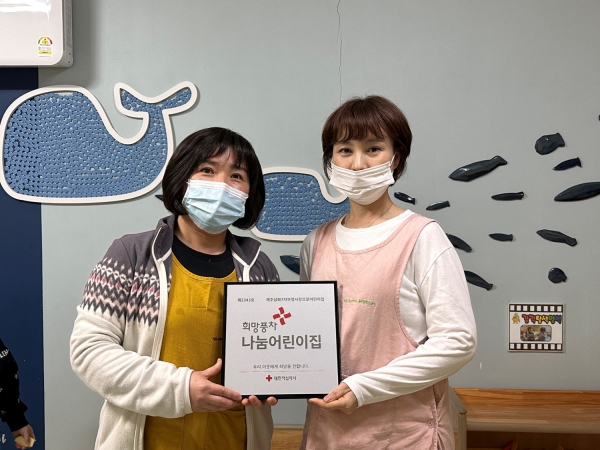 부영 제주삼화7차 부영 사랑으로 어린이집 관계자가 적십자 희망풍차 나눔 명패를 받고 기념 사진을 찍고 있다. (사진=부영그룹)