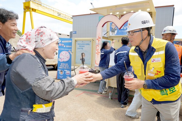 SK오션플랜트는 현장 근무자의 온열질환 예방을 위한 현장 이벤트를 진행하고 있다. 사진은 현장에 방문해 근로자에게 음료를 건내는 이승철 SK오션플랜트 대표의 모습 (사진=SK오션플랜트)